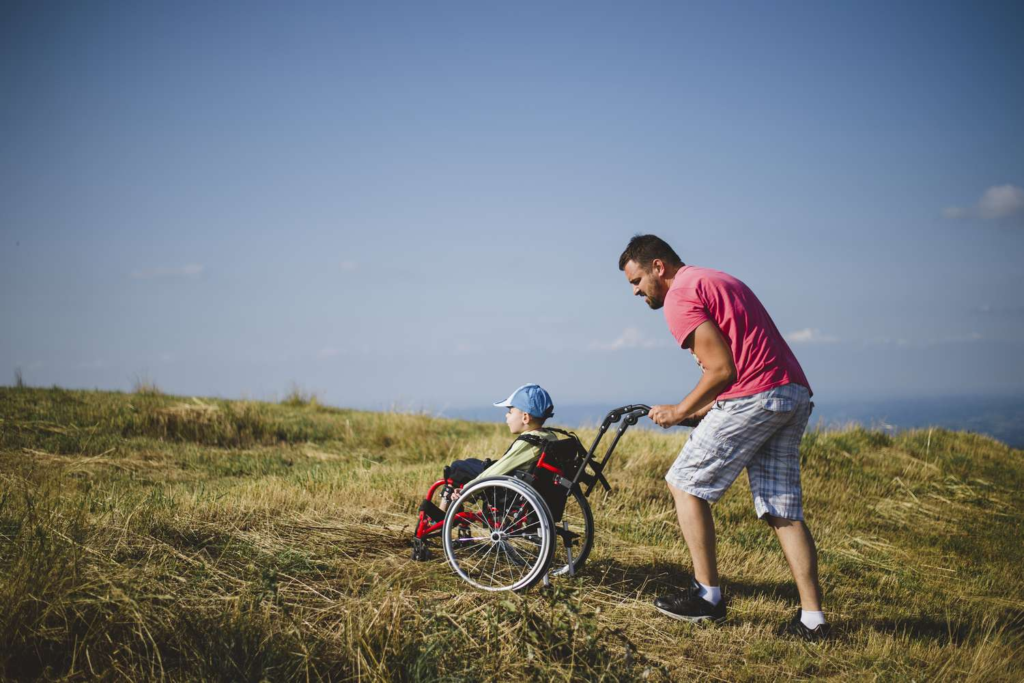Accessible Canada: Wheelchair-Friendly Road Trip Routes 3 A man travelling with his kid in a wheelchair