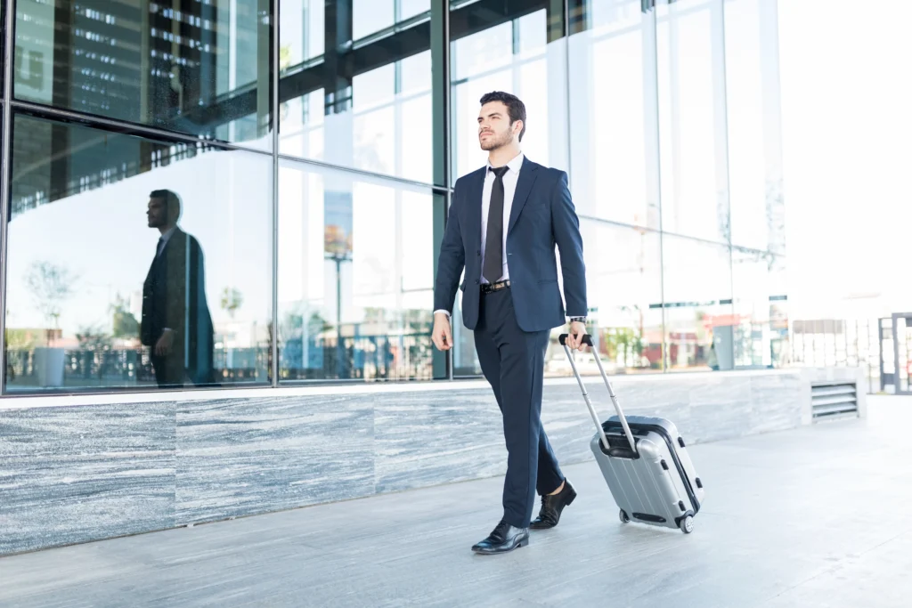 full length handsome young man suit walking with luggage outside office building Renting a car at LAX is one of the smartest decisions a business traveler can make when arriving in Los Angeles. After hours on a flight, the last thing most professionals want is to deal with long waits for taxis or expensive ride-shares. Los Angeles is a city built around driving — its meetings, events, and opportunities are often spread across miles of scenic highways and bustling streets. Having your own car the moment you land gives you the control, comfort, and efficiency you need to make the most of every minute of your trip.