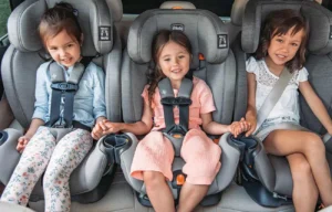 Car Rental and Car Seat Options: Should You Bring Your Own or Add One to Your Booking? 3 children in the backseat of a car