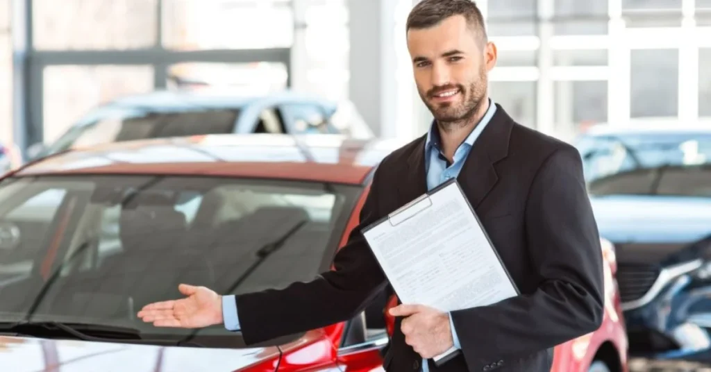 Car rental employee showing rental car